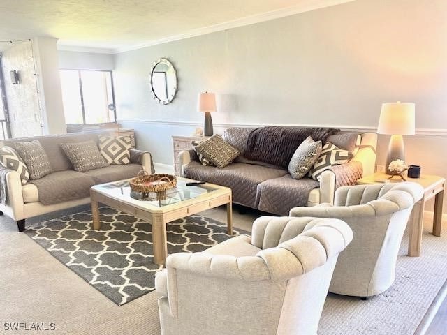 carpeted living room with ornamental molding