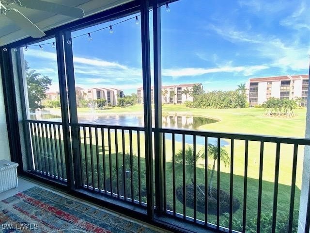 unfurnished sunroom featuring a water view