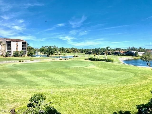 view of property's community featuring a water view and a yard