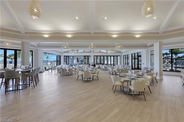 dining room with beam ceiling and light hardwood / wood-style flooring