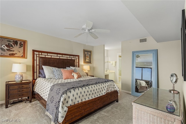 bedroom with ensuite bathroom, ceiling fan, and light colored carpet