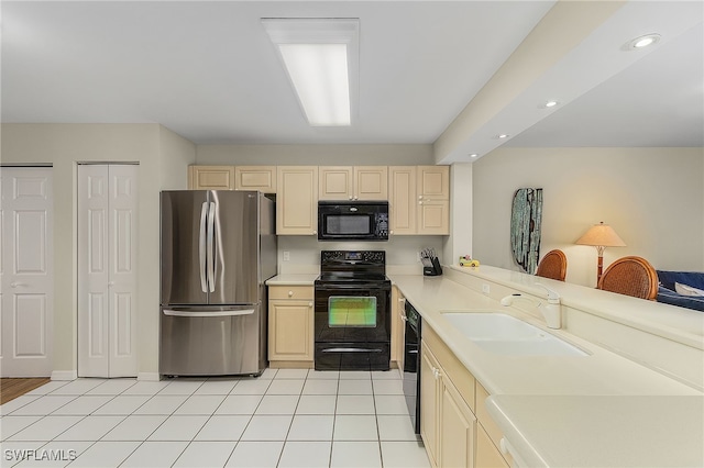 kitchen with kitchen peninsula, sink, light tile patterned flooring, and black appliances