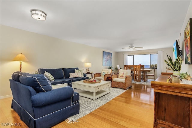 living room with ceiling fan and hardwood / wood-style floors