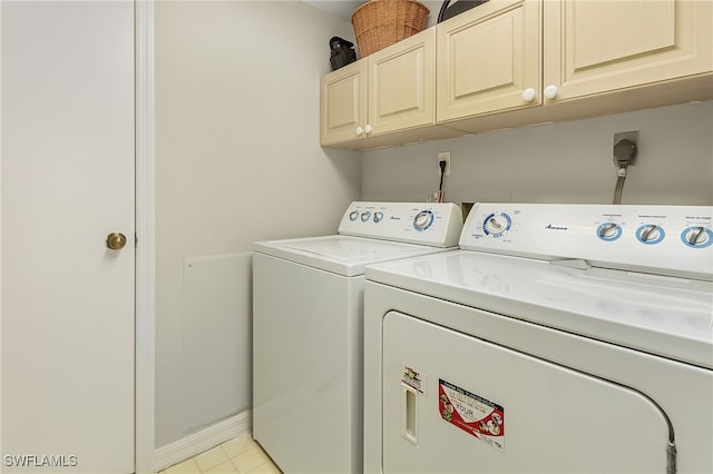 laundry room with cabinets and washer and clothes dryer