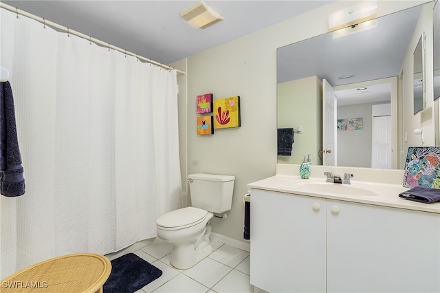 bathroom with tile patterned flooring, vanity, and toilet