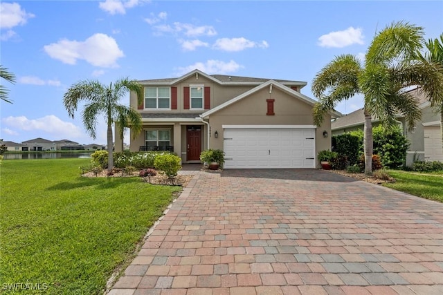 view of front of home with a front yard and a garage