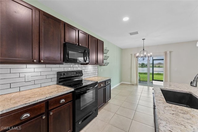 kitchen featuring sink, a notable chandelier, decorative light fixtures, decorative backsplash, and black appliances