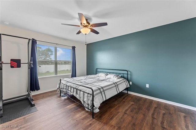 bedroom with ceiling fan and dark hardwood / wood-style flooring