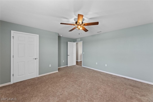 unfurnished bedroom with ceiling fan and carpet floors