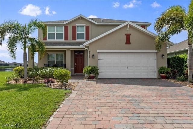 view of front of property featuring a front yard and a garage