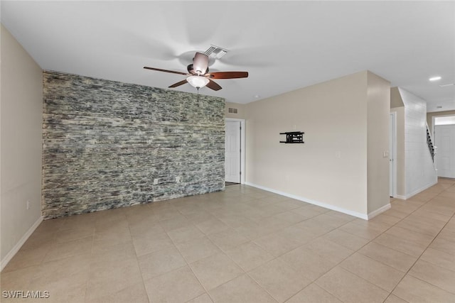 tiled empty room with ceiling fan