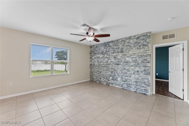 unfurnished room featuring ceiling fan and light tile patterned floors