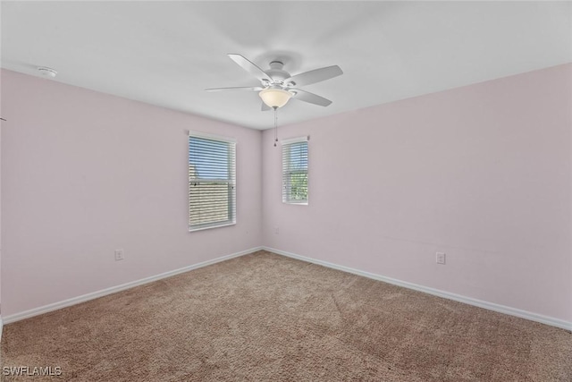 unfurnished room with ceiling fan and carpet floors