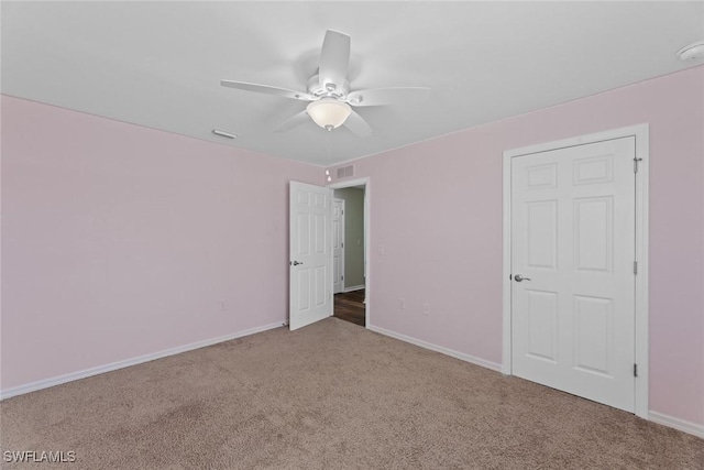 carpeted spare room with ceiling fan