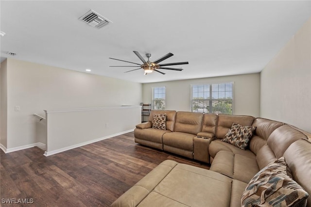 living room with dark hardwood / wood-style flooring and ceiling fan