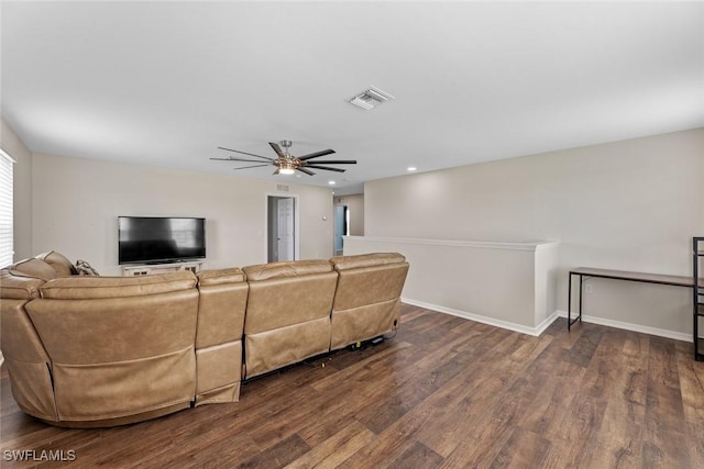 living room with ceiling fan and dark hardwood / wood-style flooring