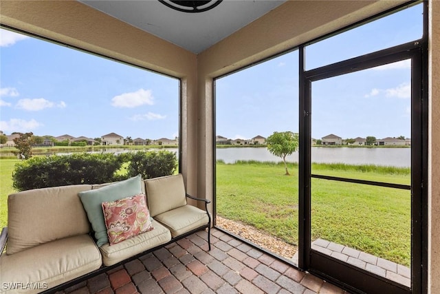 sunroom / solarium with a wealth of natural light and a water view