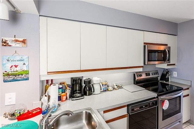 kitchen featuring white cabinets, sink, and stainless steel appliances