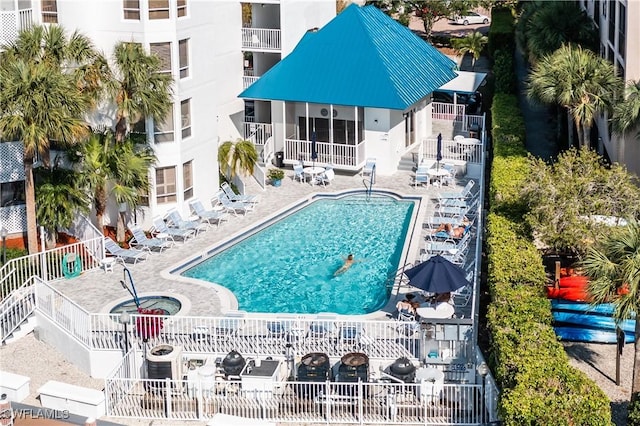 view of pool featuring a patio and a sunroom