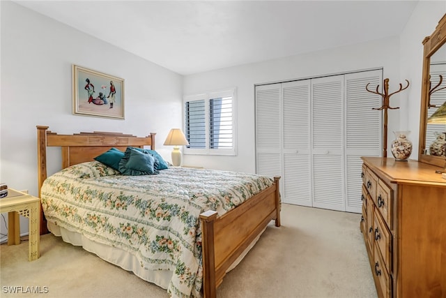 bedroom with a closet and light colored carpet