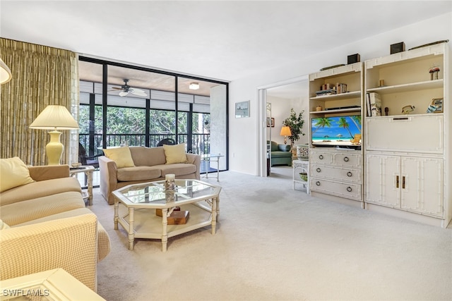 carpeted living room with a wall of windows and a ceiling fan