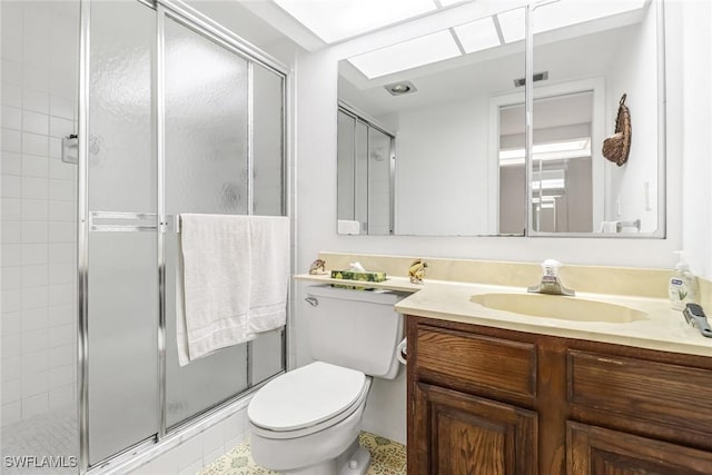 full bathroom featuring toilet, vanity, a shower stall, and visible vents