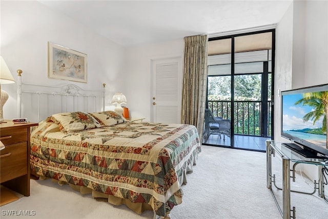 bedroom featuring expansive windows, light colored carpet, and access to exterior