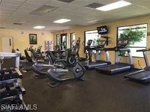 exercise room featuring a drop ceiling