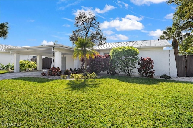 ranch-style home featuring a carport and a front lawn