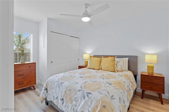 bedroom featuring ceiling fan, a closet, and light wood-type flooring