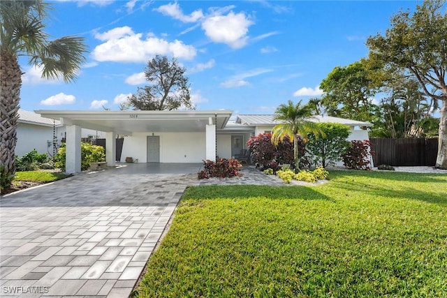 ranch-style house with a carport and a front lawn