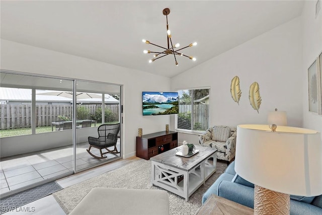 living room featuring lofted ceiling and a chandelier