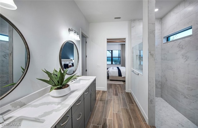 bathroom featuring vanity and tiled shower