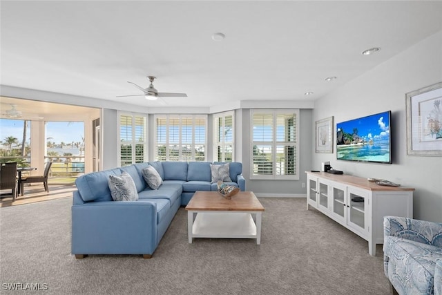 living room featuring light carpet and ceiling fan