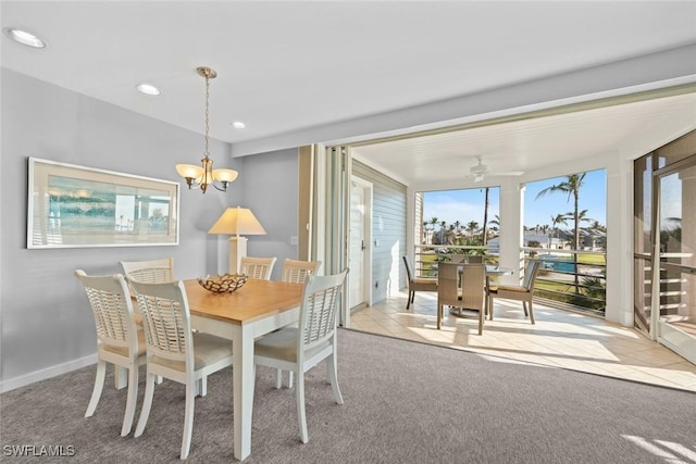 dining area with light carpet and ceiling fan with notable chandelier