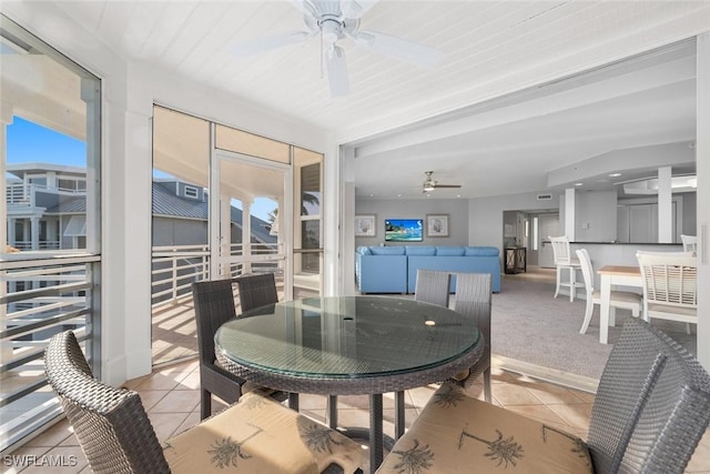 sunroom / solarium featuring ceiling fan