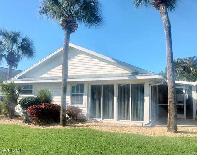 exterior space with a sunroom and a yard