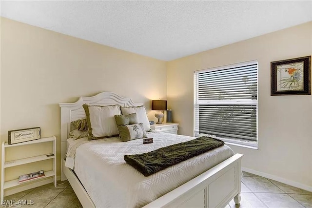 tiled bedroom with a textured ceiling