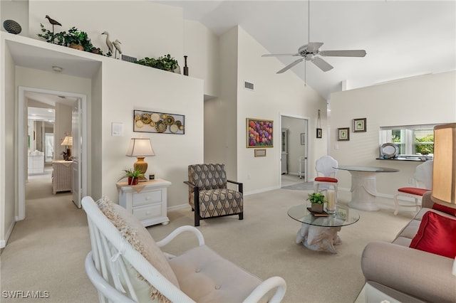 living room with ceiling fan, light colored carpet, and high vaulted ceiling