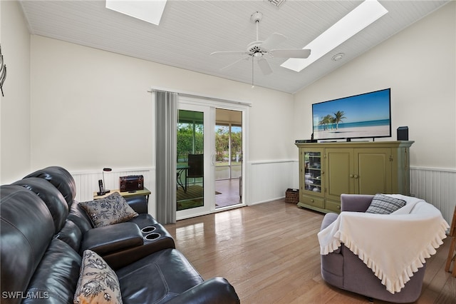 living room featuring ceiling fan, light wood-type flooring, wood ceiling, and lofted ceiling with skylight