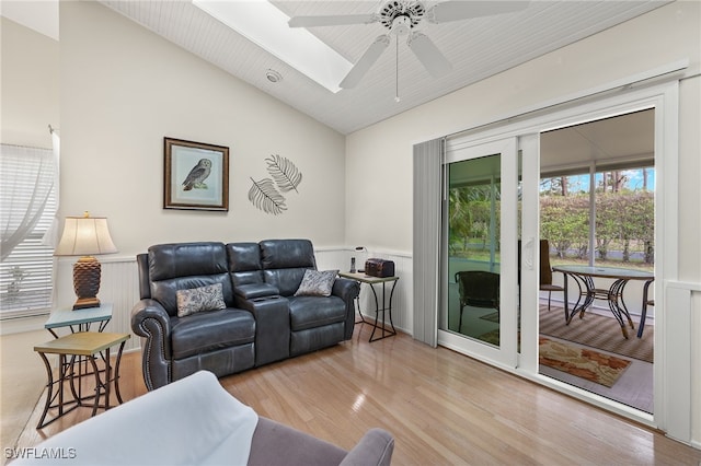 living room featuring ceiling fan, light hardwood / wood-style floors, wood ceiling, and vaulted ceiling