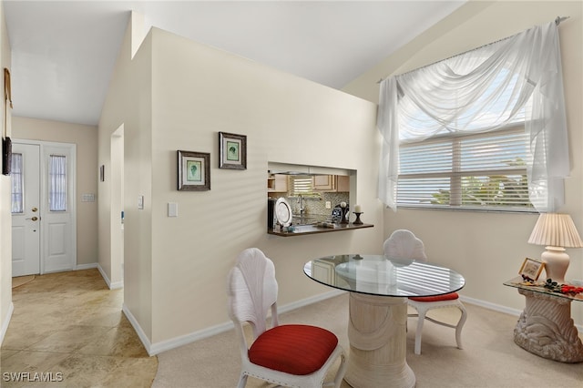 dining area featuring vaulted ceiling