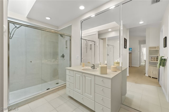 bathroom with tile patterned flooring, vanity, and a shower with shower door