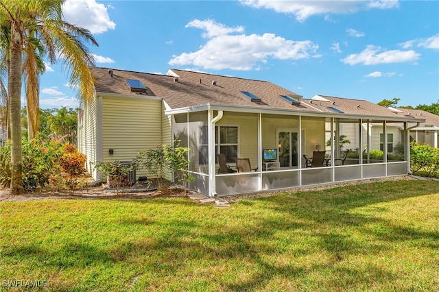 back of house featuring a sunroom and a yard