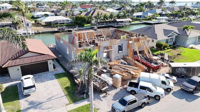 drone / aerial view with a water view and a residential view