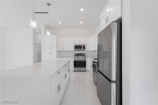 kitchen with white cabinets, a kitchen island, stainless steel appliances, and hanging light fixtures