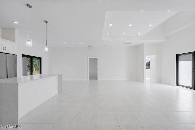 spare room with a towering ceiling and french doors