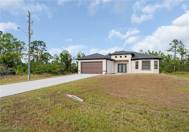 view of front of property featuring a garage and a front lawn