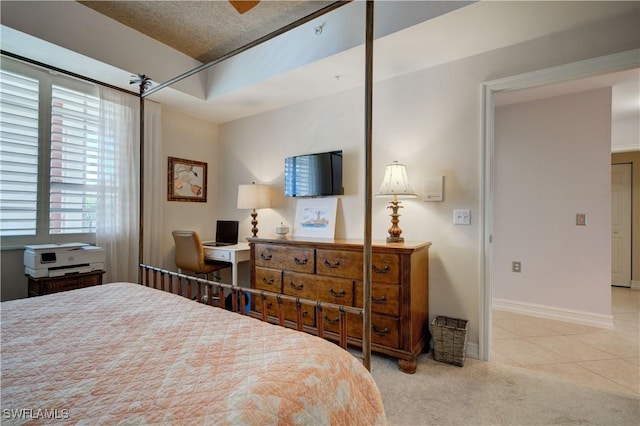 tiled bedroom featuring a textured ceiling and ceiling fan