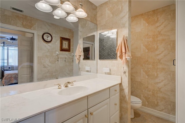 bathroom with tile patterned flooring, vanity, and toilet